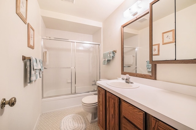 2103 E Newark Rd, Lapeer, MI 48446 - full bathroom with toilet, vanity, shower / bath combination with glass door, and baseboards