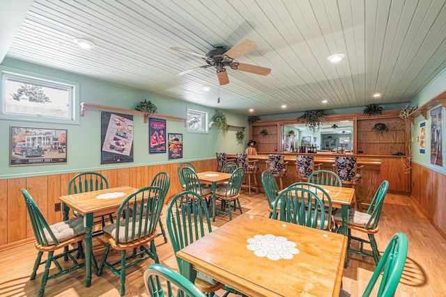 2103 E Newark Rd, Lapeer, MI 48446 - dining space featuring a wainscoted wall, wooden walls, a ceiling fan, light wood-style flooring, and wood ceiling