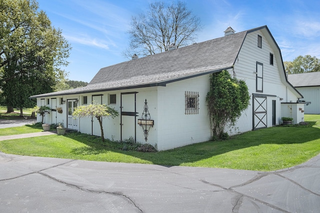 2103 E Newark Rd, Lapeer, MI 48446 - view of home's exterior featuring a barn, a lawn, roof with shingles, and an outdoor structure