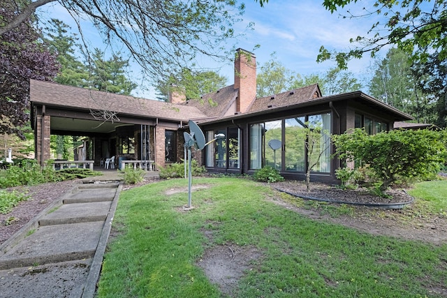 2103 E Newark Rd, Lapeer, MI 48446 - back of property featuring a yard, a chimney, and brick siding