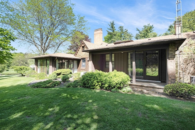 2103 E Newark Rd, Lapeer, MI 48446 - rear view of property with a chimney, a yard, and board and batten siding