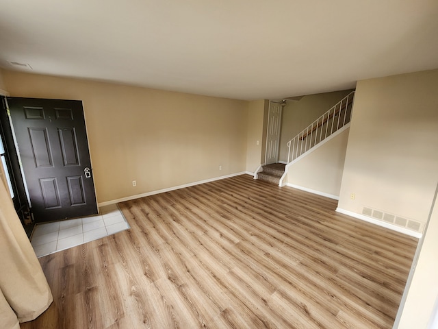 50013 S Jimmy, Chesterfield, MI 48047 - unfurnished living room with stairway, wood finished floors, and baseboards