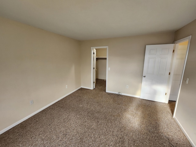 50013 S Jimmy, Chesterfield, MI 48047 - unfurnished bedroom with baseboards, a spacious closet, and dark carpet
