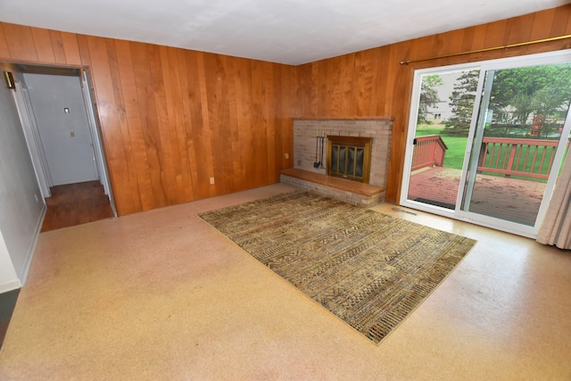11365 Runnells Dr, Clio, MI 48420 - unfurnished living room with wood walls and a brick fireplace