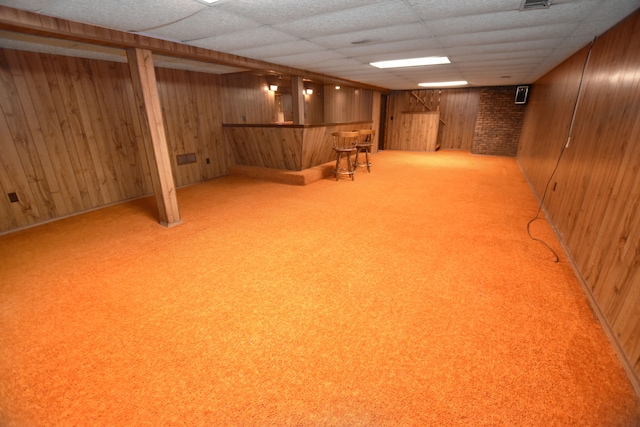 11365 Runnells Dr, Clio, MI 48420 - finished below grade area with wood walls, a bar, light carpet, and a drop ceiling