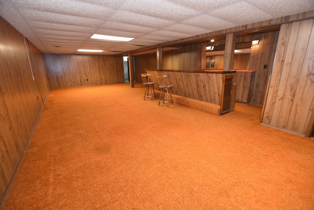 11365 Runnells Dr, Clio, MI 48420 - finished basement featuring bar area, wooden walls, carpet floors, and a drop ceiling