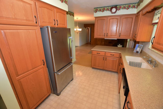 11365 Runnells Dr, Clio, MI 48420 - kitchen with freestanding refrigerator, a sink, a chandelier, light floors, and light countertops
