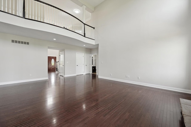 1840 Tapadera Dr, Ann Arbor, MI 48103 - unfurnished living room with baseboards, dark wood finished floors, and a high ceiling