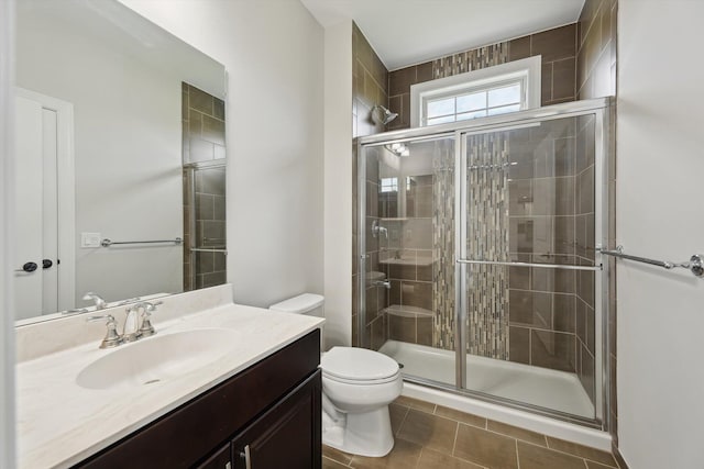 1840 Tapadera Dr, Ann Arbor, MI 48103 - full bath featuring a stall shower, toilet, vanity, and tile patterned flooring