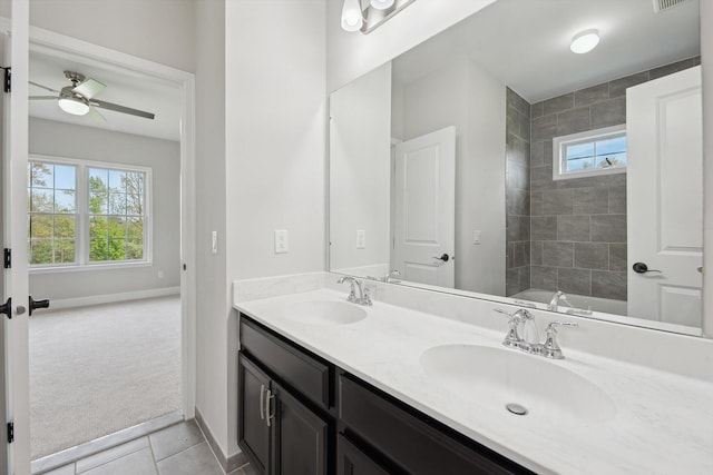 1840 Tapadera Dr, Ann Arbor, MI 48103 - full bathroom with double vanity, tile patterned floors, a ceiling fan, and baseboards