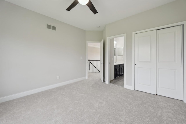 1840 Tapadera Dr, Ann Arbor, MI 48103 - unfurnished bedroom featuring light colored carpet, baseboards, a closet, connected bathroom, and ceiling fan