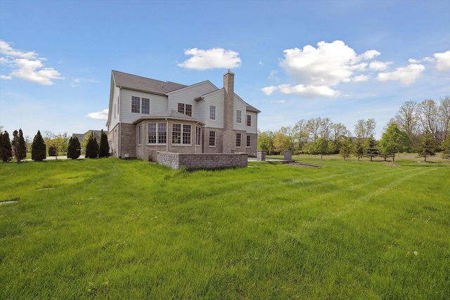 1840 Tapadera Dr, Ann Arbor, MI 48103 - rear view of house with a chimney, a yard, and brick siding