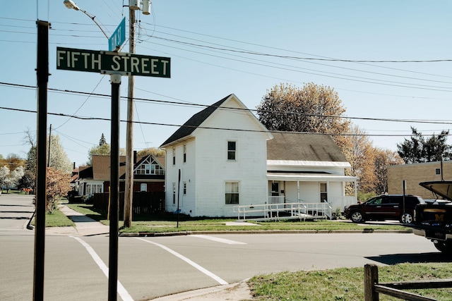 109 E 5th St, Shelby, MI 49455 - view of asphalt street featuring curbs, street lights, and sidewalks