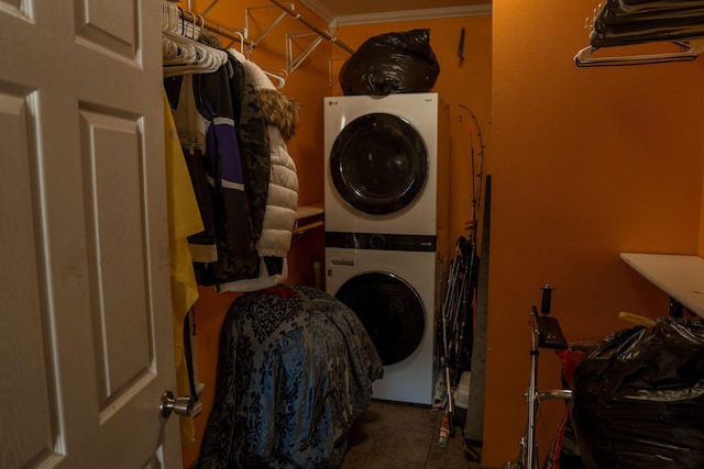 109 E 5th St, Shelby, MI 49455 - clothes washing area with stacked washing machine and dryer, tile patterned floors, and ornamental molding