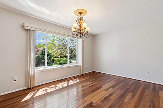2374 Berwick Dr, Canton, MI 48188 - empty room featuring a chandelier, hardwood / wood-style flooring, and baseboards