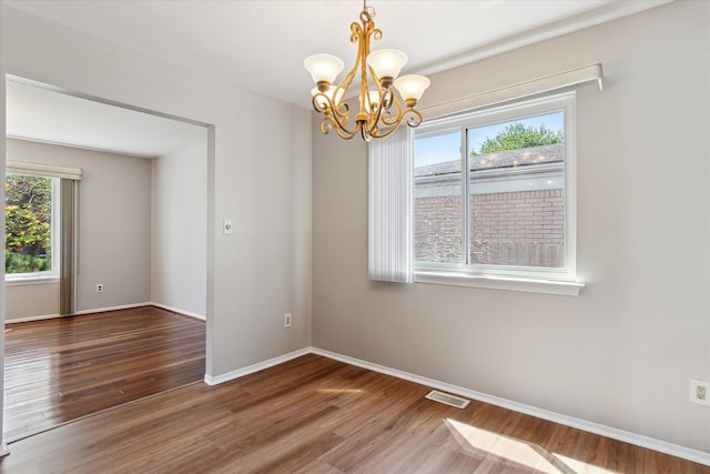 2374 Berwick Dr, Canton, MI 48188 - empty room featuring a chandelier, wood finished floors, and baseboards