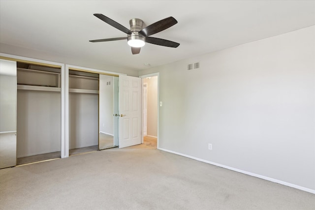 2374 Berwick Dr, Canton, MI 48188 - unfurnished bedroom with multiple closets, light colored carpet, baseboards, and a ceiling fan