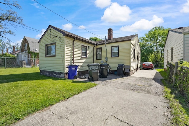 19433 Fenmore St, Detroit, MI 48235 - back of house featuring a chimney and driveway