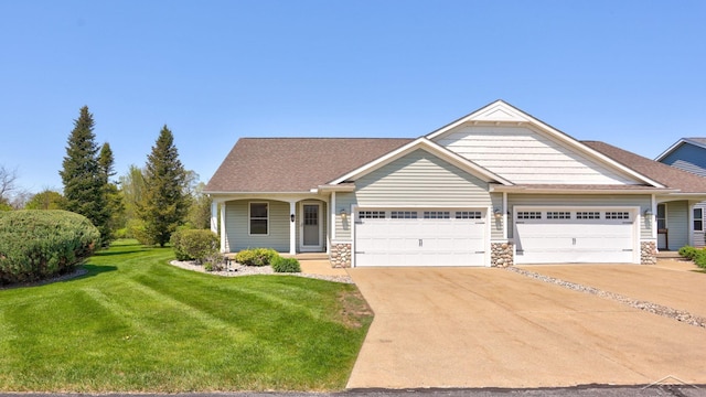 1 Sanctuary Way, Freeland, MI 48623 - view of front of property with an attached garage, a front yard, driveway, stone siding, and roof with shingles