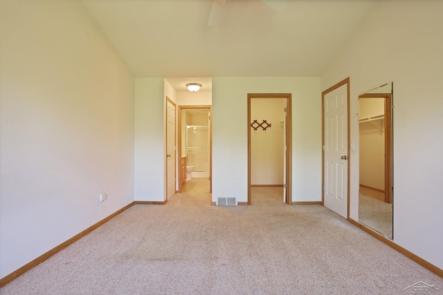 1 Sanctuary Way, Freeland, MI 48623 - unfurnished bedroom with a walk in closet, light carpet, a closet, and baseboards