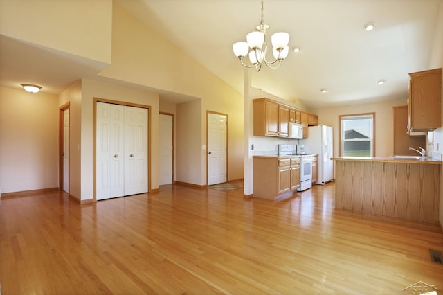 1 Sanctuary Way, Freeland, MI 48623 - unfurnished living room featuring a sink, light wood-style floors, a chandelier, baseboards, and lofted ceiling