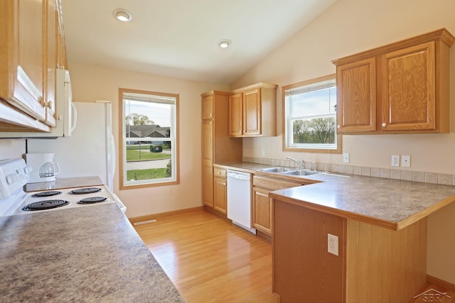 1 Sanctuary Way, Freeland, MI 48623 - kitchen with a sink, white appliances, a peninsula, a breakfast bar area, and vaulted ceiling