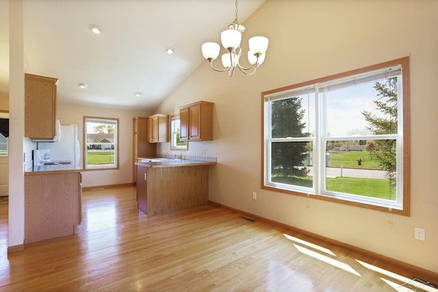 1 Sanctuary Way, Freeland, MI 48623 - kitchen with a sink, vaulted ceiling, light wood-type flooring, and a peninsula