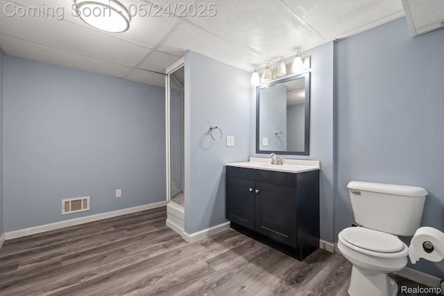 508 Chamberlain St Unit 8, Flushing, MI 48433 - bathroom with wood finished floors, vanity, toilet, baseboards, and a shower stall