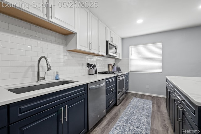 508 Chamberlain St Unit 8, Flushing, MI 48433 - kitchen featuring appliances with stainless steel finishes, a sink, tasteful backsplash, and white cabinets