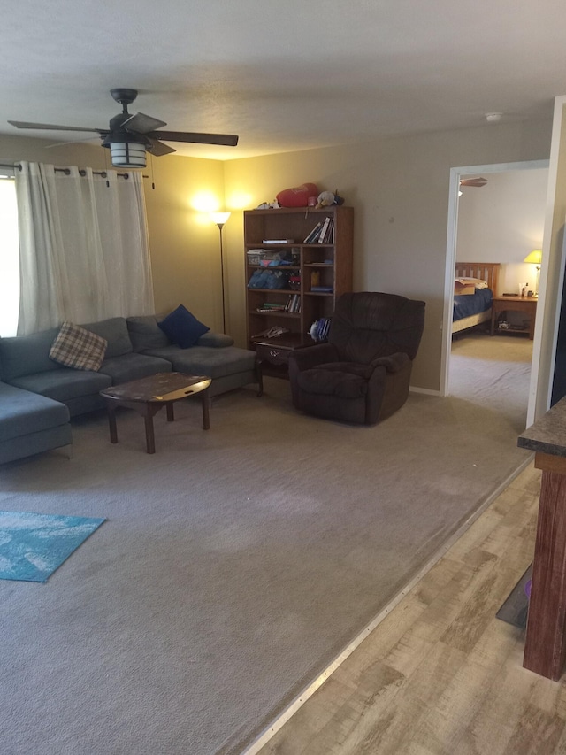 living room with carpet flooring and ceiling fan