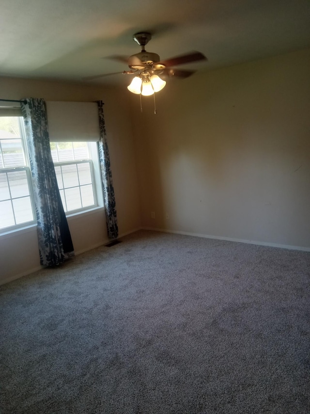 unfurnished room with ceiling fan, carpet, and baseboards
