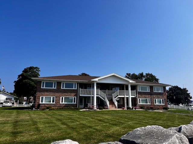 304 S Ferry St Unit 7, Ludington, MI 49431 - view of front of house with stairs and brick siding