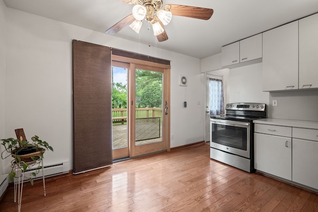 1837 Henbert Rd, West Bloomfield, MI 48324 - kitchen with stainless steel electric range oven, light wood-style floors, ceiling fan, and white cabinets