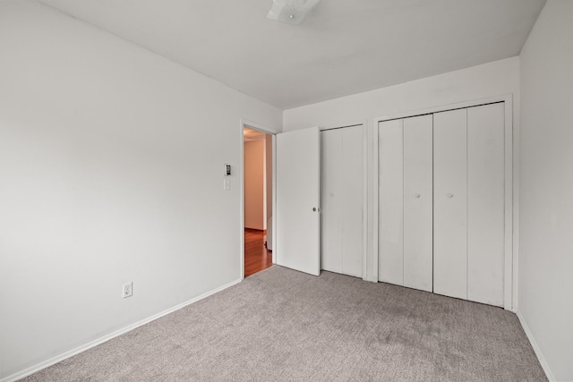 1837 Henbert Rd, West Bloomfield, MI 48324 - unfurnished bedroom featuring two closets, carpet flooring, and baseboards
