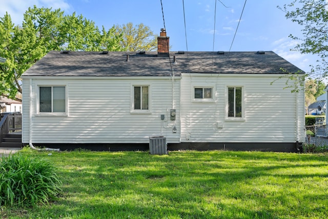 11354 Jackson Ave, Warren, MI 48089 - back of property with a chimney, a shingled roof, and central AC unit