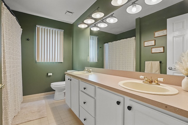 full bathroom with toilet, tile patterned flooring, double vanity, and baseboards