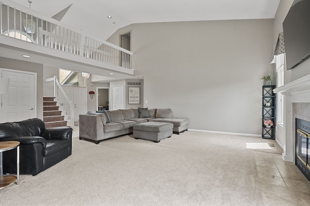 living room with stairs, a fireplace, high vaulted ceiling, carpet flooring, and baseboards