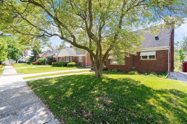 1526 S Gulley Rd, Dearborn Heights, MI 48125 - view of front of house with a front yard, brick siding, and a chimney