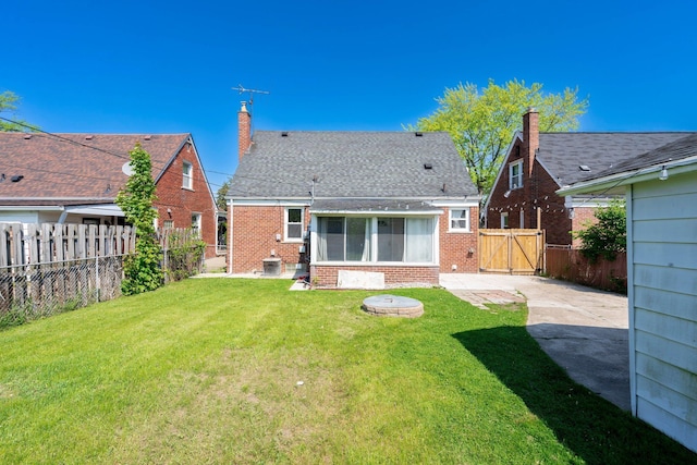1526 S Gulley Rd, Dearborn Heights, MI 48125 - rear view of house featuring a gate, brick siding, and a chimney