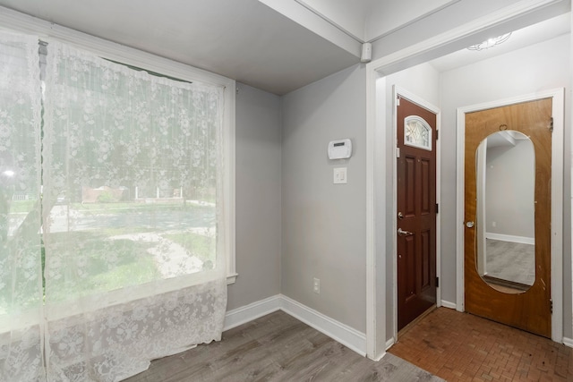 1526 S Gulley Rd, Dearborn Heights, MI 48125 - entrance foyer featuring baseboards, arched walkways, and wood finished floors