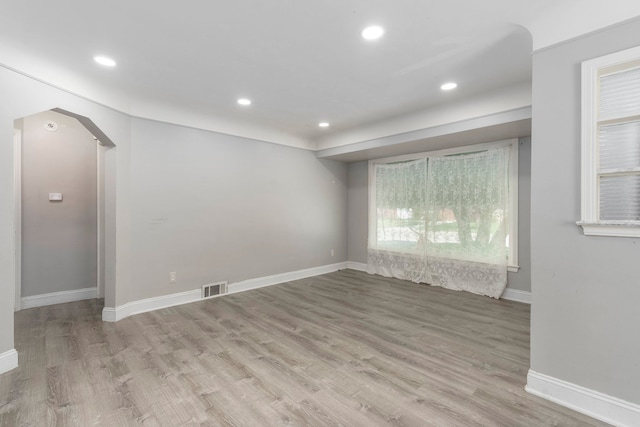 1526 S Gulley Rd, Dearborn Heights, MI 48125 - empty room with recessed lighting, wood finished floors, arched walkways, and baseboards