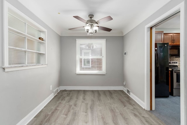 1526 S Gulley Rd, Dearborn Heights, MI 48125 - unfurnished dining area with light wood-style floors, a ceiling fan, and baseboards