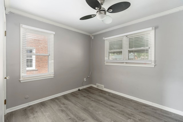 1526 S Gulley Rd, Dearborn Heights, MI 48125 - spare room featuring plenty of natural light, wood finished floors, and crown molding