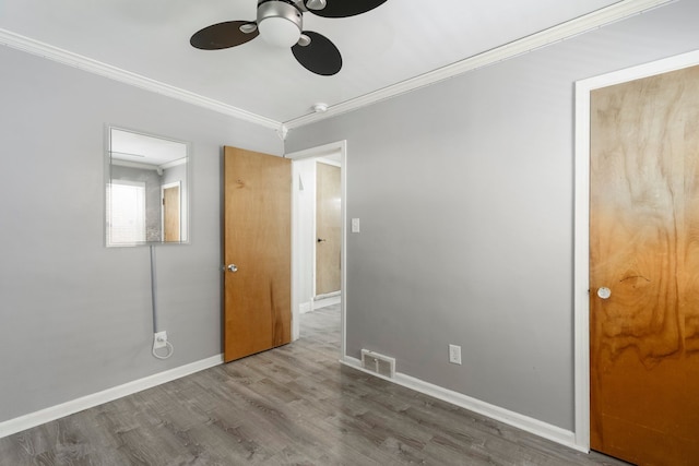 1526 S Gulley Rd, Dearborn Heights, MI 48125 - unfurnished bedroom featuring wood finished floors, ornamental molding, baseboards, and ceiling fan