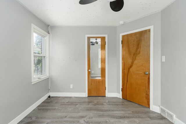 1526 S Gulley Rd, Dearborn Heights, MI 48125 - unfurnished bedroom featuring crown molding, wood finished floors, and baseboards