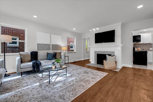 17550 Ohio St, Detroit, MI 48221 - living room with crown molding, wood finished floors, recessed lighting, a tile fireplace, and baseboards