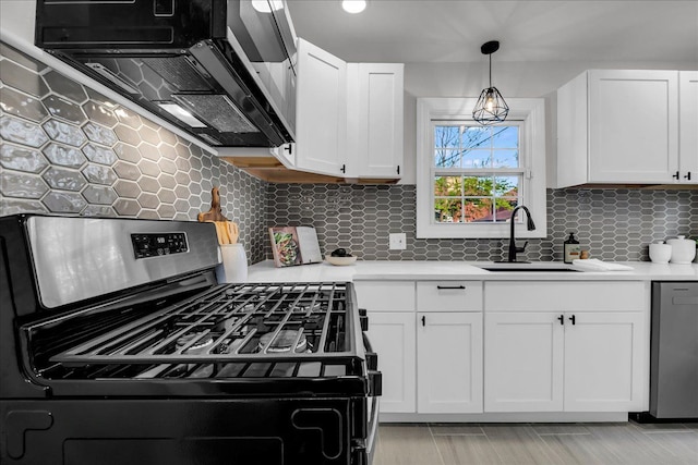 17550 Ohio St, Detroit, MI 48221 - kitchen with appliances with stainless steel finishes, a sink, light countertops, white cabinets, and decorative backsplash
