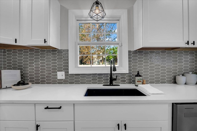 17550 Ohio St, Detroit, MI 48221 - kitchen with a sink, white cabinets, light countertops, and backsplash