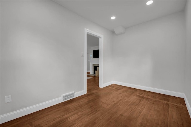 17550 Ohio St, Detroit, MI 48221 - spare room featuring baseboards, wood finished floors, a fireplace with flush hearth, and recessed lighting