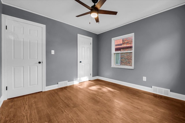 17550 Ohio St, Detroit, MI 48221 - unfurnished bedroom with wood finished floors, baseboards, crown molding, and ceiling fan